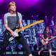 The Goo Goo Dolls in 2019, possibly ruminating on who gets to sing lead for “Have A Holly Jolly Christmas.”